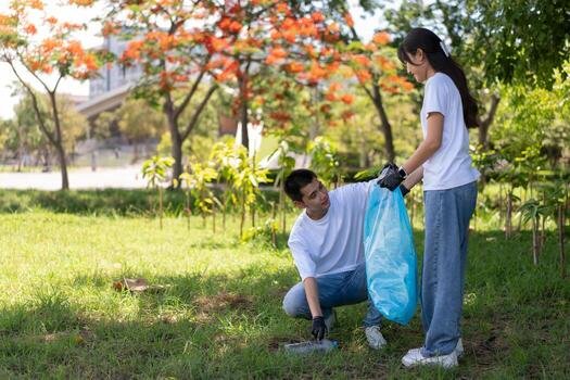 happy-young-asian-students-diverse-volunteers-with-garbage-bags-cleaning-area-in-the-park-the-concept-of-environmental-conservation-on-world-environment-day-recycling-charity-for-sustainability-photo